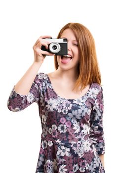 A portrait of a beautiful young girl taking a picture with a vintage camera, isolated on white background.