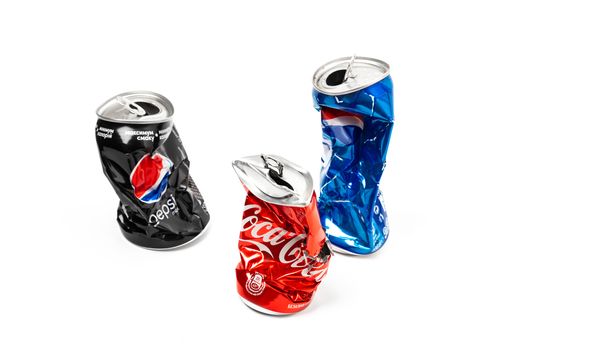 CHISINAU, MOLDOVA - August 20, 2019: Studio photo of empty and crashed Pepsi and Cola aluminum cans isolated on white background