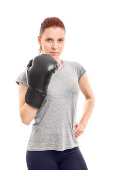 A portrait of a beautiful young girl posing with a boxing glove, isolated on white background.