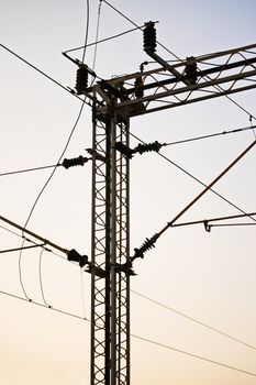 Railroad power transmission line tower during sunset.