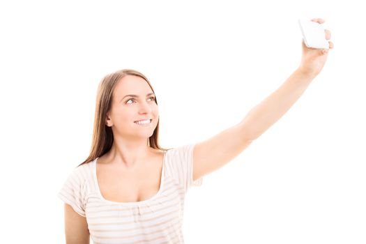 Beautiful smiling young girl taking a selfie, isolated on white background.