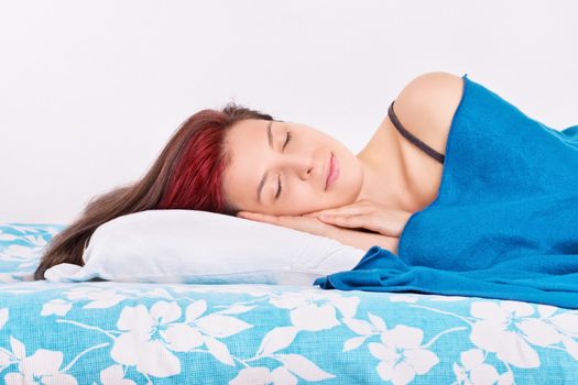 Good sleep is very important. Beautiful young girl calmly sleeping in her bed.