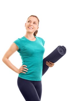 Going out for a workout. Beautiful young girl holding an exercise mat, isolated on white background.
