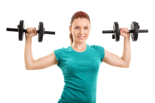 Lift and hold. Beautiful young girl lifting up two dumbbells, isolated on white background.