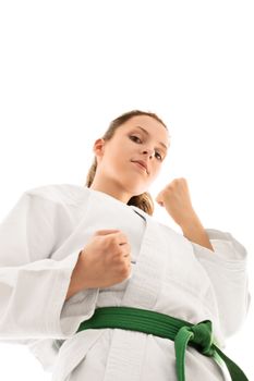 Come at me. Bottom up view of a beautiful young girl in kimono with green belt, isolated on white background.