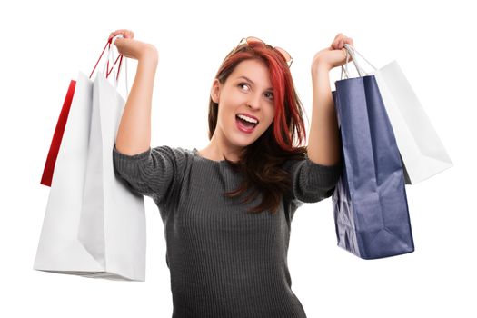 Beautiful happy young girl holding shopping bags, isolated on white background. Successful day shopping.