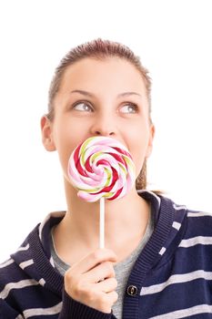 Beautiful young girl holding a lollipop in front of her mouth, isolated on white background.