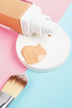 Liquid foundation makeup with brush and sponge on beautiful background.