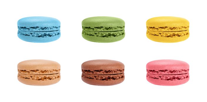 Close up set of assorted colors fresh traditional French macaroon pastry cookies (macaron, macaroni) isolated on white background, low angle side view