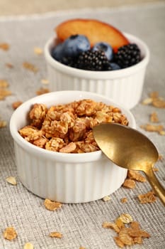 Close up portion of muesli granola breakfast with yogurt, fruits and berries, high angle view