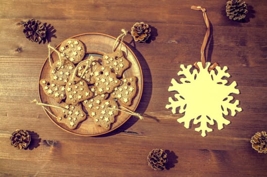 Christmas theme with cookies, spruce cones on a dark background. Flat lay