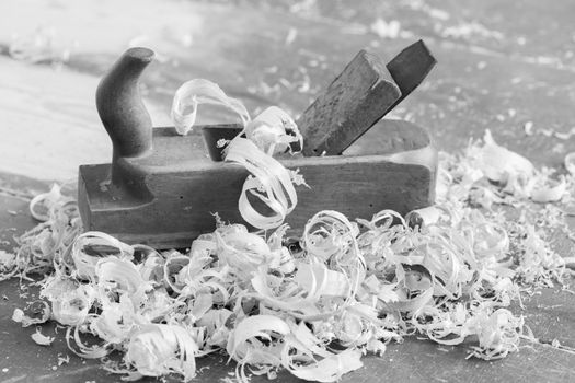 Old wooden hand plane for woodworking. Black and white picture.