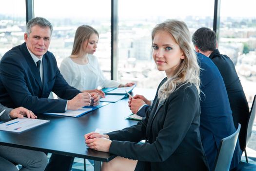 Serious business people work with graphs and diagrams at meeting at office table