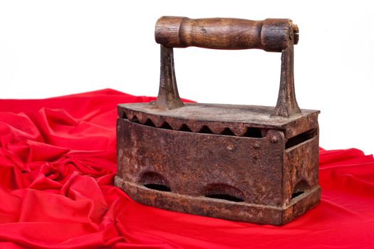 Old rusty iron and a piece of red textile on isolated background