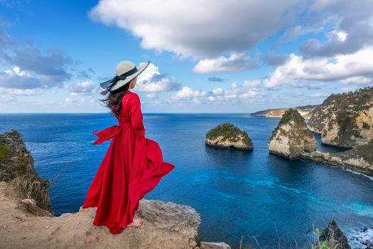 Woman standing on Diamond beach in Nusa penida island, Bali in Indonesia.