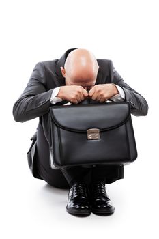 Business problems and failure at work concept - unhappy crying tired or stressed businessman in depression hand holding briefcase sitting down floor white isolated