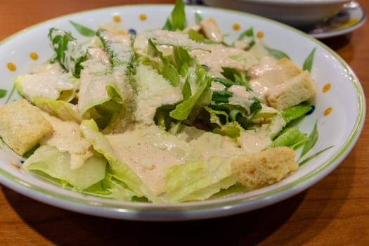 Green leafy salad with croutons in a plate