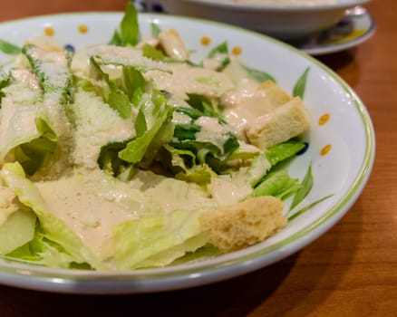 Green leafy salad with croutons in a plate