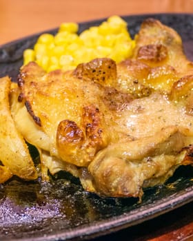 Chicken, French fries, and corn in metal plate