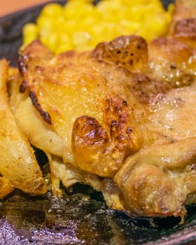 Chicken, French fries, and corn in metal plate