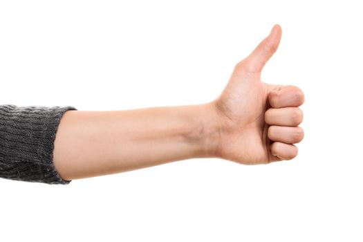 Female hand giving approval with thumb up gesture, isolated on white background.