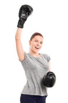 A portrait of a beautiful fit young girl with boxing gloves cheering, isolated on white background.