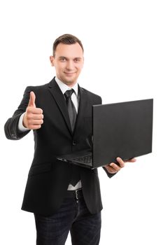 A portrait of a young businessman in a suit holding a laptop and giving thumbs up, isolated on white background.