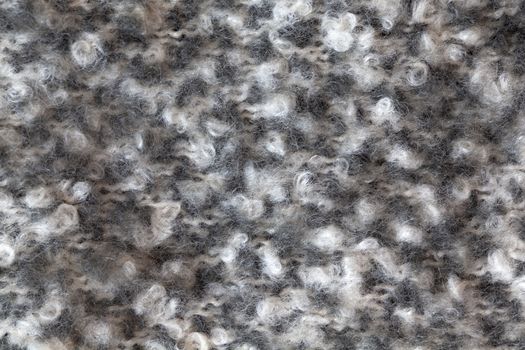 Woollen fluffy boucle scarf, macro. Soft calm colors merino wool backdrop, closeup. Autumn and winter flat lay. Scandinavian minimal style.