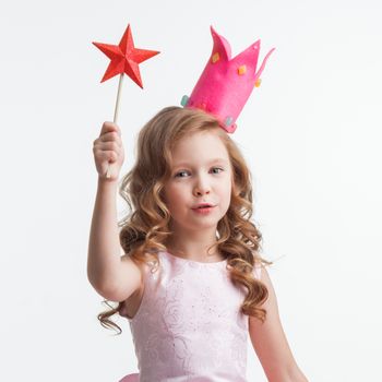 Little fairy girl in pink dress and crown with magic wand putting spell , isolated on white background
