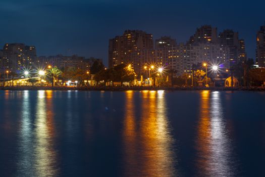 a wide long exposure cityscape shoot from izmir city - dark pastel colors. photo has taken izmir/turkey.