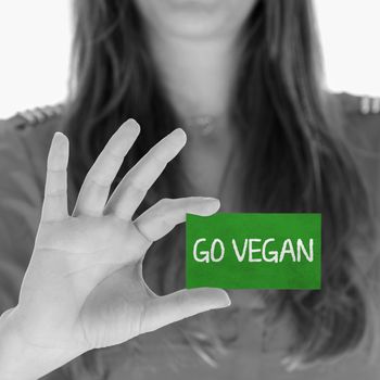 Woman showing a small message: Go Vegan