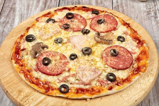 Pizza on an old wooden studio background