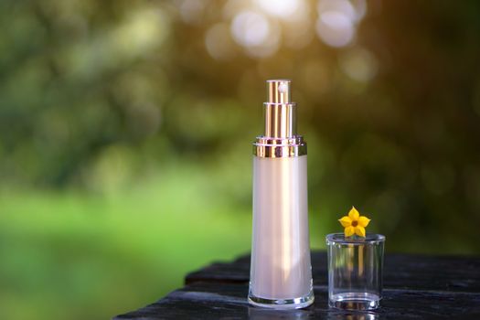 Blank spray cosmetic bottles - Mockup with green nature and bokeh background.