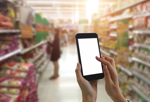 Female hand hold black smartphone at supermarket and checking shopping list