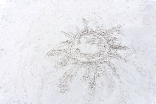 Smile sun Drawing on a white sand beach.