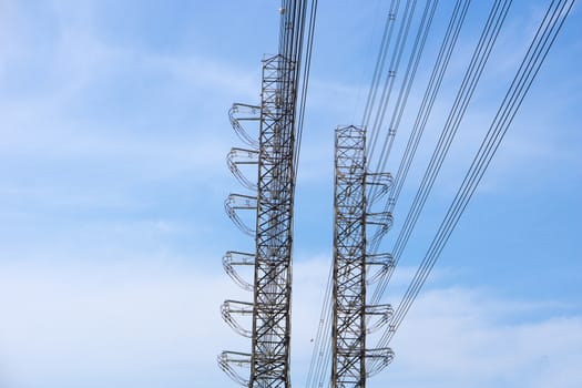 High-voltage of power transmission towers on blue sky background.