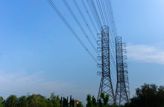 High-voltage of power transmission towers on blue sky background.