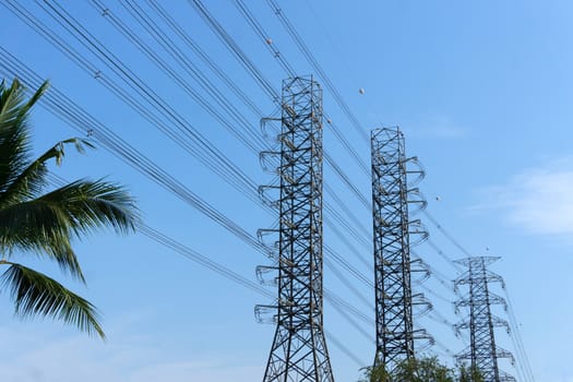 High-voltage of power transmission towers on blue sky background.