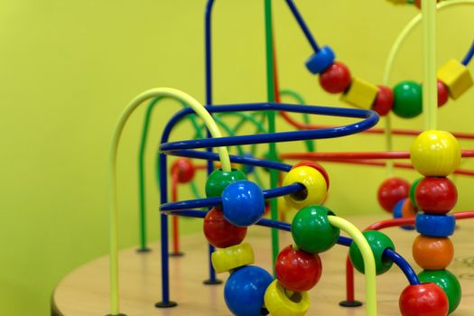 Educational wooden Logic toy with paths in Toddler baby in nursery room.