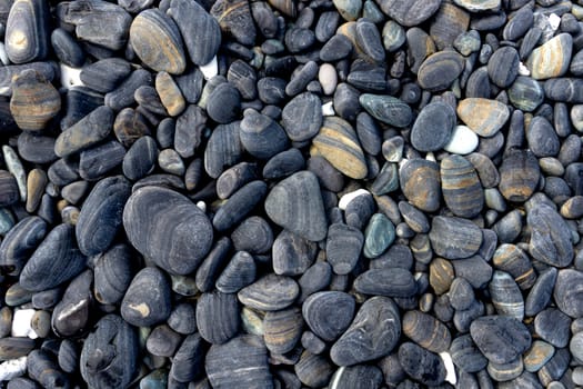 Black pebble stones island in Koh hin ngam, Tarutao National Park, Satun, Thailand.