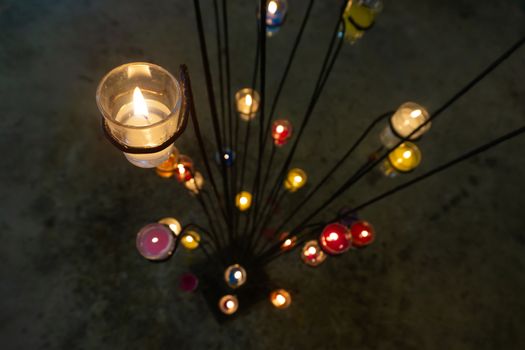 Candles placed in glass, placed on an iron base for decorations.