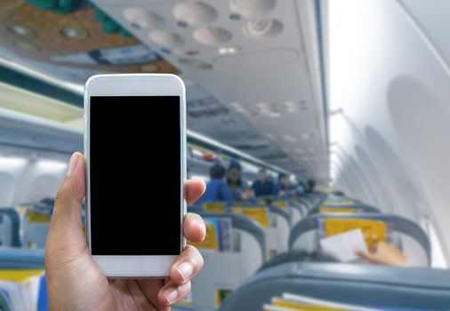 Man use your phone in airplane blurred background - mockup template