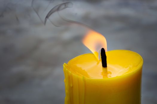 A candle is an ignitable wick embedded in wax, or another flammable solid substance such as tallow, that provides light, and in some cases, a fragrance. 