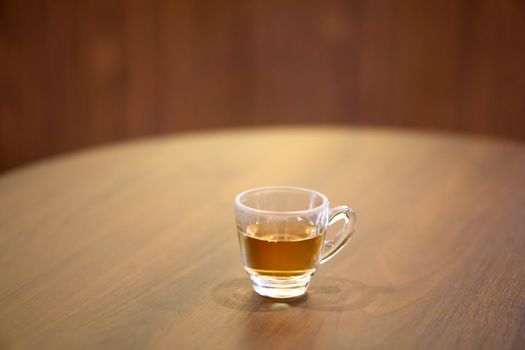 Cup of Lingzhi mushroom hot tea on wood table.