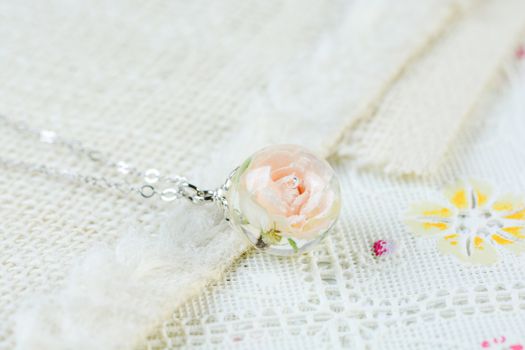 Dried rose in crystal clear resin pendant necklace, pendant with a real rose. 
