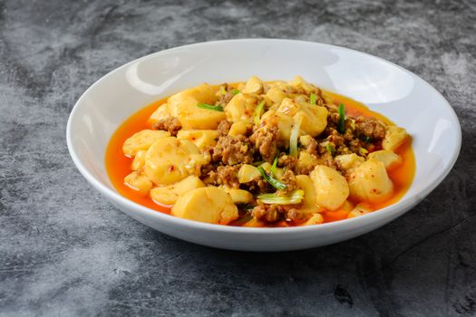 Mapo Tofu, popular Chinese dish.  The classic recipe consists of silken tofu, ground pork or beef and Sichuan peppercorn to name a few main ingredients.
