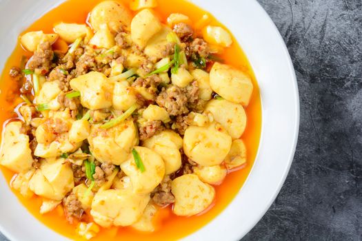 Mapo Tofu, popular Chinese dish.  The classic recipe consists of silken tofu, ground pork or beef and Sichuan peppercorn to name a few main ingredients.
