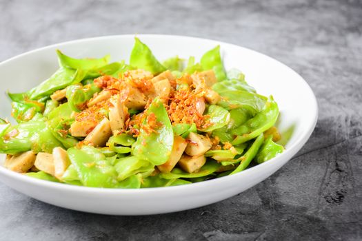 Stir Fry Snow Peas with Vietnamese Grilled Pork Sausage, topping with crispy fried shallots and garlics
