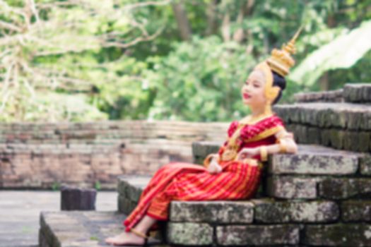 Asian woman wearing typical, traditional Thai Dress. It is literally means "Thai outfit", National costume.
