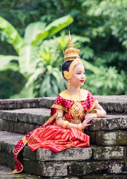 Asian woman wearing typical, traditional Thai Dress. It is literally means "Thai outfit", National costume.
